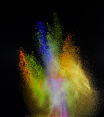 Launched colorful powder, isolated on black background