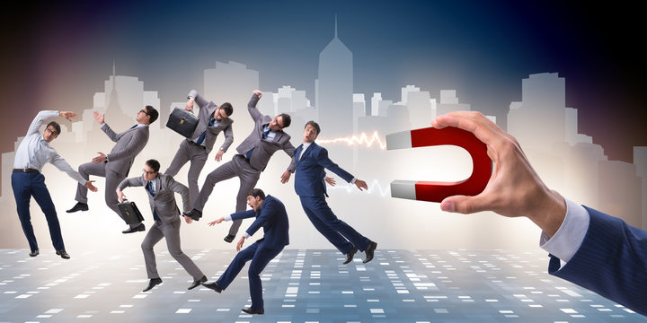 Businessman in recruitment concept with horseshoe magnet