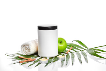Natural spa beauty treatment cleansing products with apple on white background.