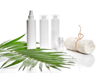Set of cosmetic products in white containers on light background.
