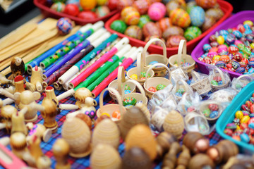 Fototapeta na wymiar Small wooden toys, Easter eggs and decorations sold on Easter market in Vilnius