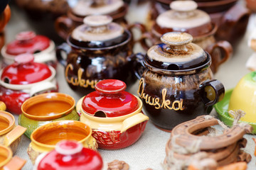 Ceramic dishes, tableware and jugs sold on Easter market in Vilnius. Jars for "SUGAR" and "SALT".