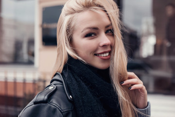 Beautiful blond woman portrait.Close-up Fashion woman portrait of young pretty trendy girl posing at the city, autumn street fashion. laughing and smiling portrait.trendy.Spring urban outfit.