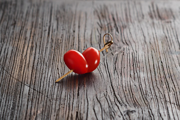Cherry tomatoes shaped of heart, Valentines day and love theme.