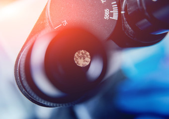 Microscope with metal lens at laboratory.