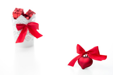  gifts in a white basket with a heart with a bow in red on a white background