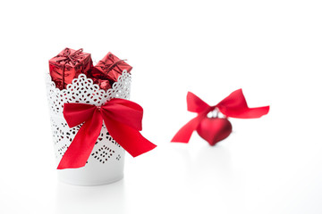 gift and heart with a bow of red color on a white background
