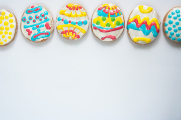 Fototapeta na wymiar Festive cookies in the form of Easter eggs on a white background. Assorted. Flat lay. Place for text.
