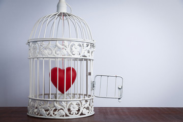 Red heart in an open cage