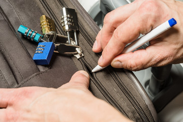 Open a locked suitcase zipper with a ballpoint pen