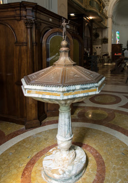 Ancient marble font with copper lid in an old church in Marostica, Italy.