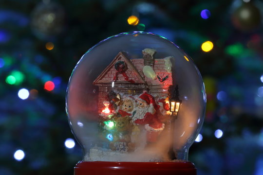 Glass snow globe with Santa Claus and lantern. Christmas toy