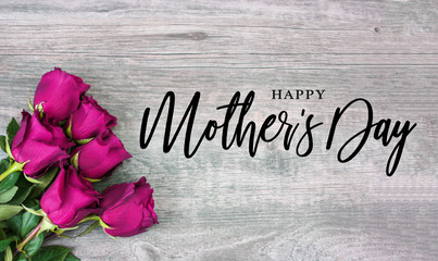 Happy Mother's Day Calligraphy with Pink Roses Over Rustic Wood Background