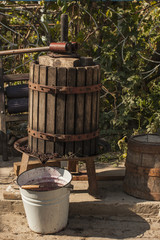 Obraz premium Wine-making. Technology of wine production. The folk tradition of making wine. Wine production in Moldova. The ancient tradition of grape processing. The squeezer is used to press the wine.