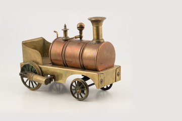 Fototapeta na wymiar Old vintage cuppreous steam train locomotive model