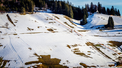 Due to the global warm up it becomes harder for the ski area's to guarantee snow. The ski slopes in the black forest often look like this where there is not enough snow to exercise the ski sport.
