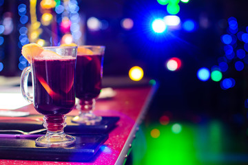 two glasses of mulled wine on a bokeh background