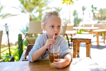 A child drinks juice on vacation.