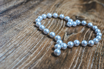 heart made of beads on a wooden background