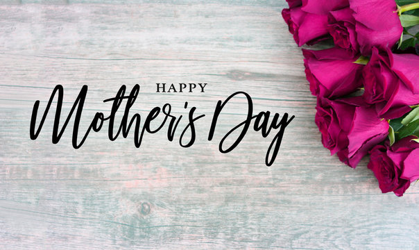 Happy Mother's Day Typography with Colorful Pink Roses in Corner Over Rustic Wood Background
