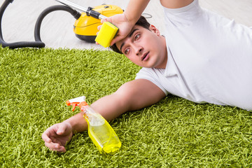 Young husband man cleaning floor at home