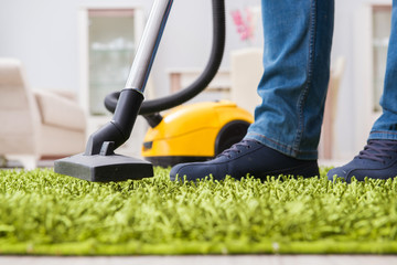 Young husband man cleaning floor at home