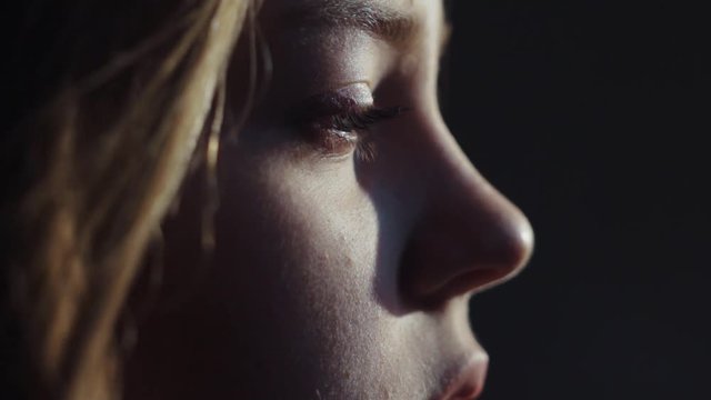close up shot face young lonely sensual virgin european blue eyes girl meditation morning sun light calm wind blowing hair