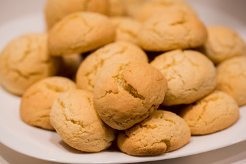 Warm, golden brown, peanut chip cookies cooling on a rack. Cookies in the oven, bun rolls