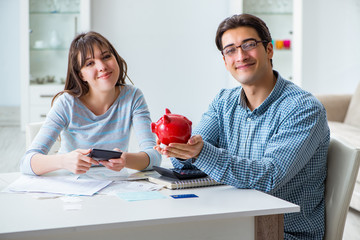 Young couple looking at family finance papers