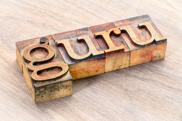 guru word abstract in wood type