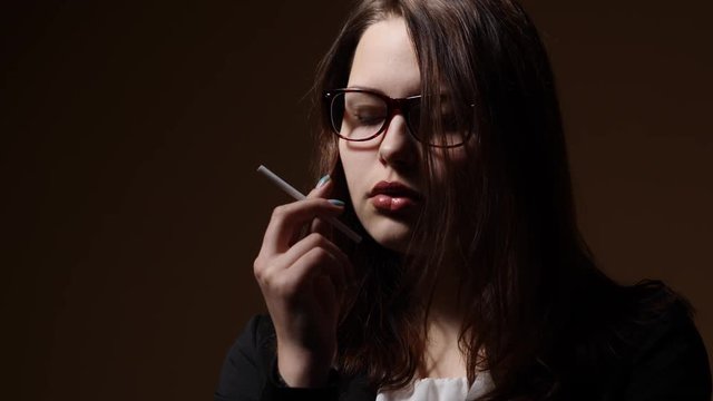Nervous teen girl with a cigarette