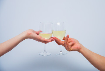 two glasses of champagne in women's hands.