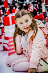 Sweet baby posing at the Christmas tree