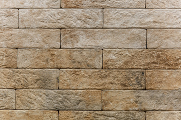 Stone wall brick texture background beige surface facade for design and decoration.