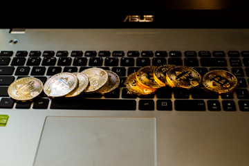 Silver and gold bitcoin on keyboard