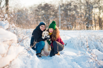 Fototapeta na wymiar Young couple portrait with dog in winter