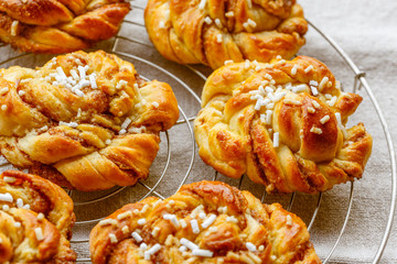 Sweet cinnamon bun rolls on cake rack