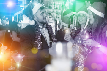 Obraz premium Guy with two girls on new year party in bar