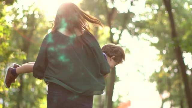 girl is holding the baby in her arms and circling