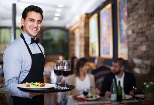 Waiter posing in restaurant