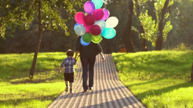 Girl with a child Walks With Her Balloons