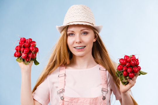 Happy woman giving radish