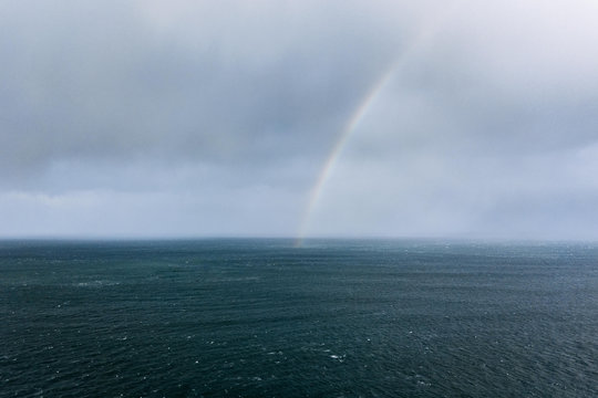 Rainbow near Dunluce Castle  in the atlantic ocean in Ireland 