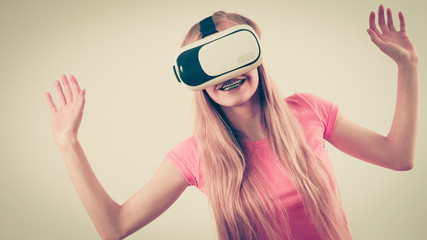 Girl wearing virtual reality goggles.