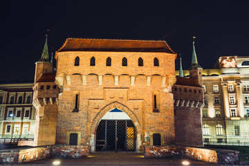 Fototapeta premium Barbican fortress in the historic center of Krakow at night, Poland