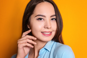 Beautiful smiling woman on color background