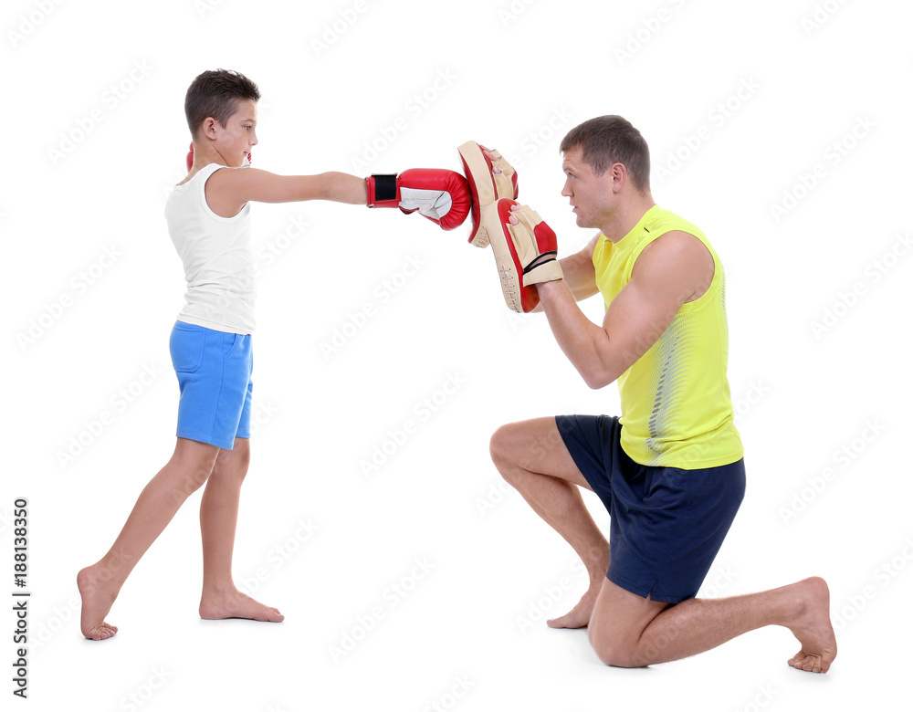 Poster cute little boy training with boxing coach, on white background