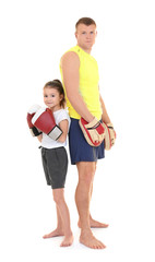 Cute little girl with boxing coach on white background