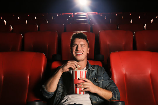 Young man watching movie in cinema