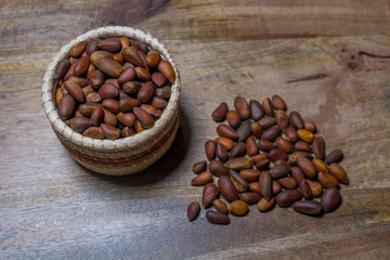 Pine nuts on wooden background